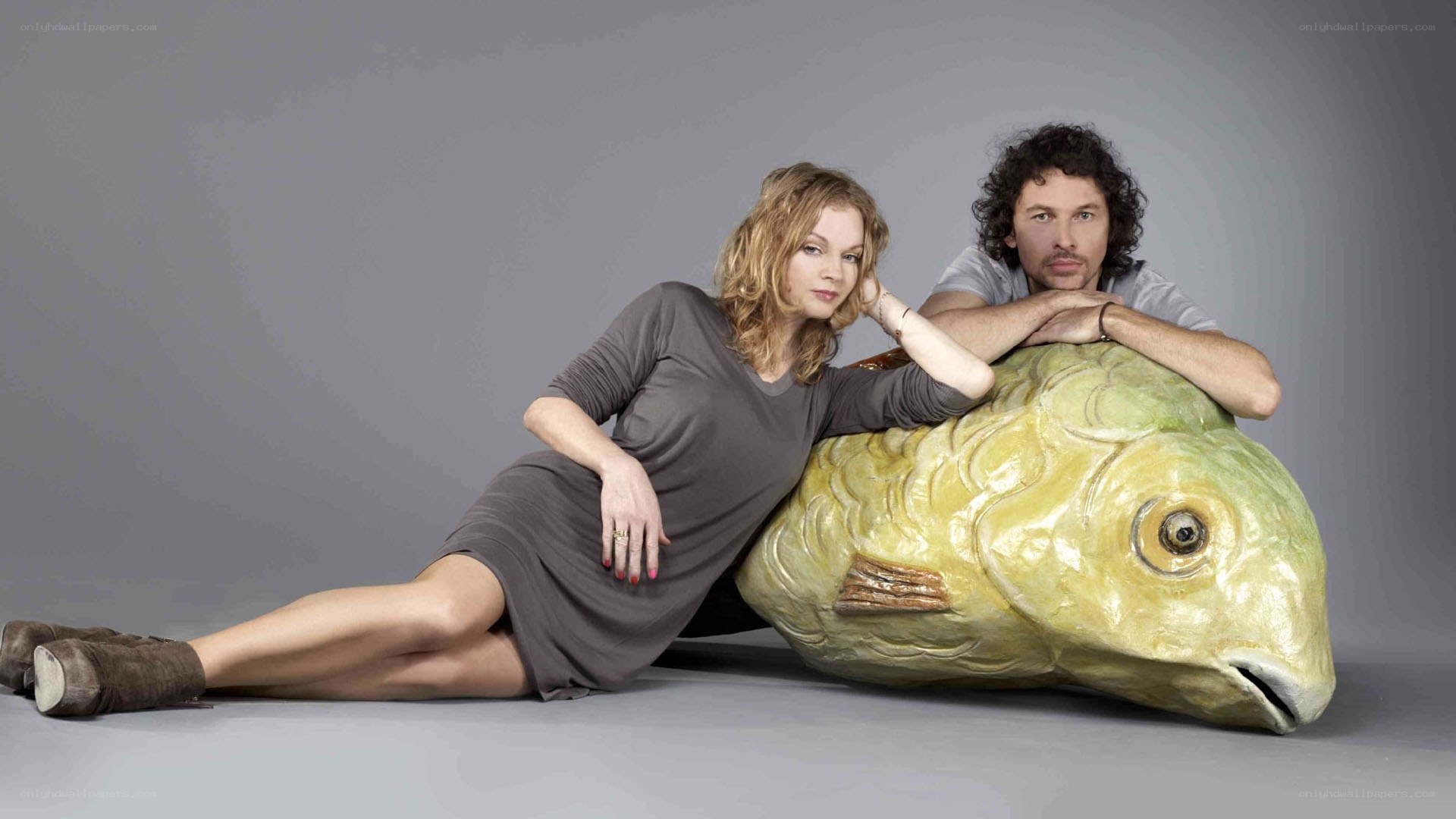 Man and woman with fish sculpture