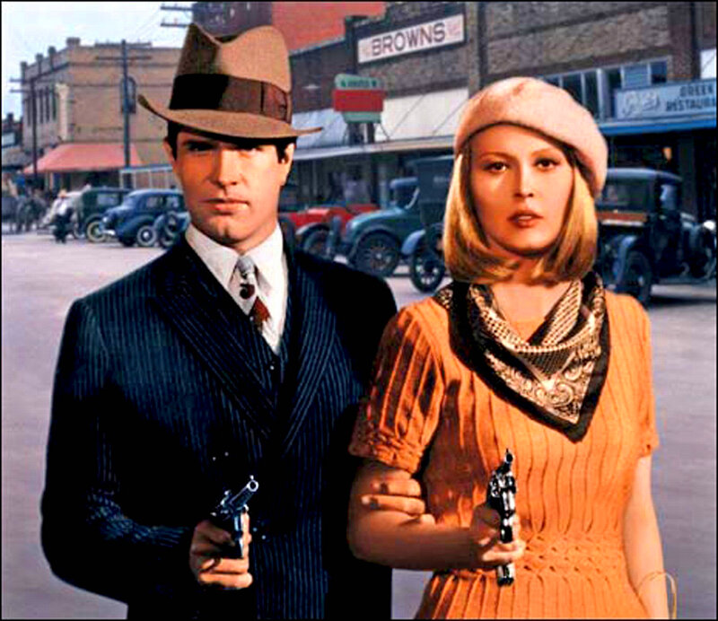 Man and woman with guns in street
