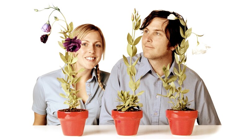 man and woman with potted plants