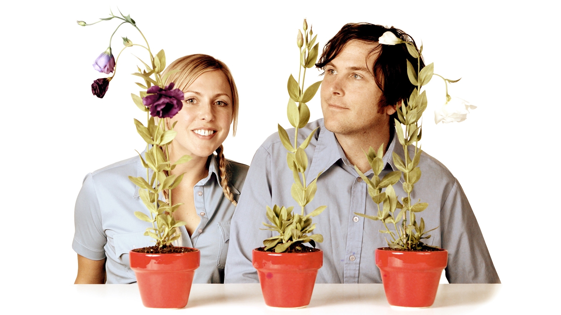 man and woman with potted plants
