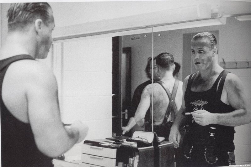 man applying makeup in mirror