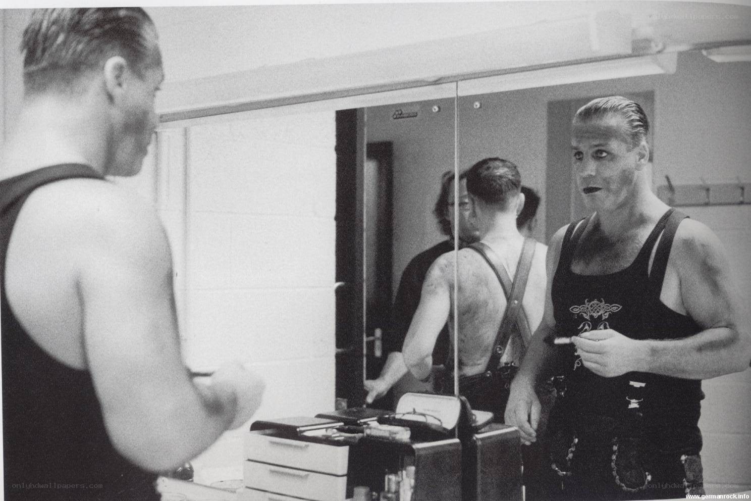 man applying makeup in mirror