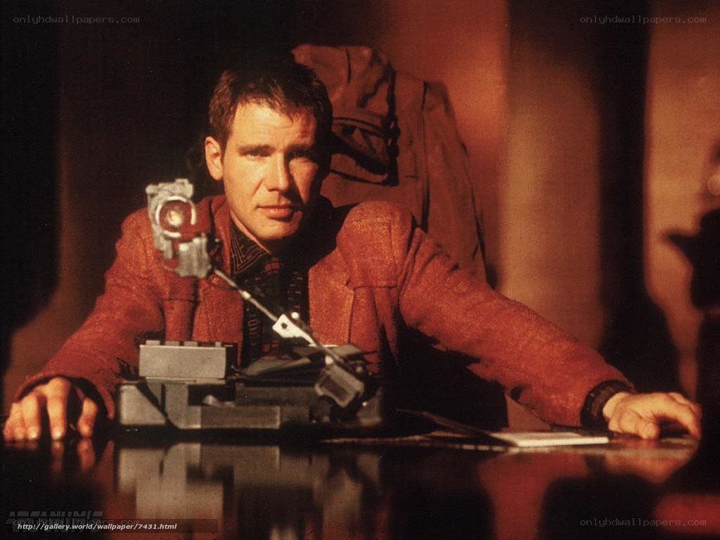 man at a desk with a device
