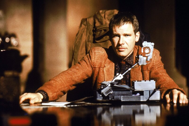 man at a desk with futuristic device