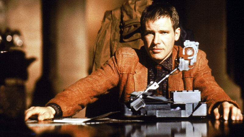man at a desk with futuristic device