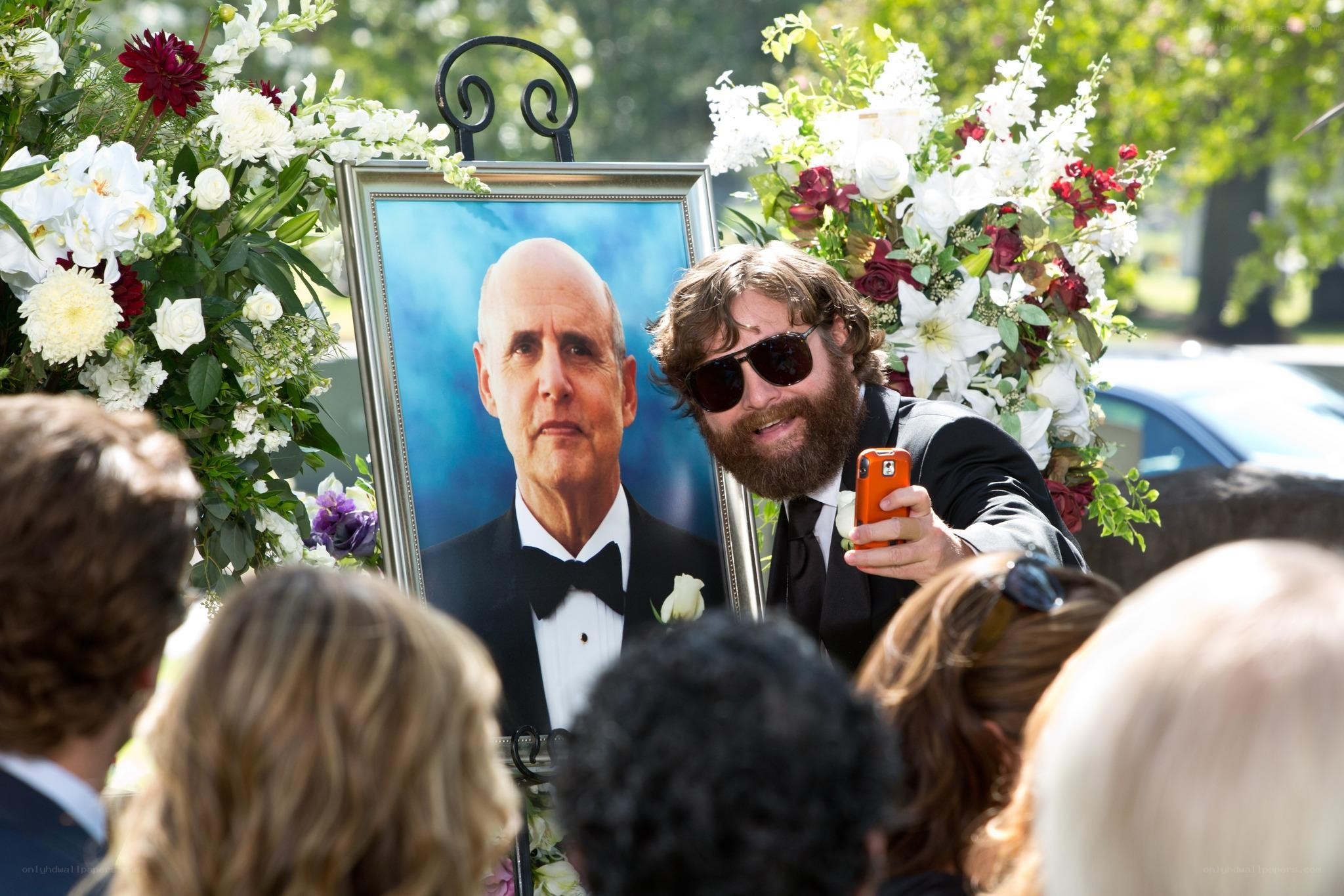 Man at a funeral taking a selfie