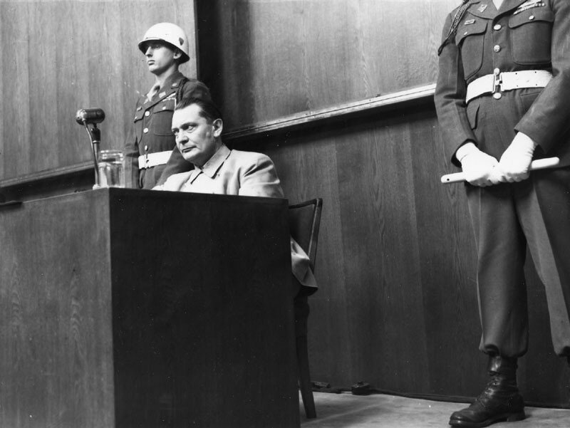 Man at a podium in a courtroom