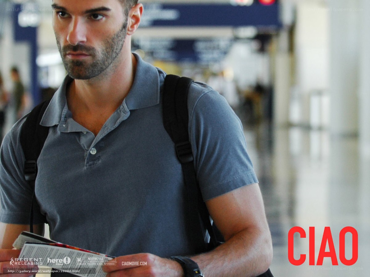 man at airport holding brochure