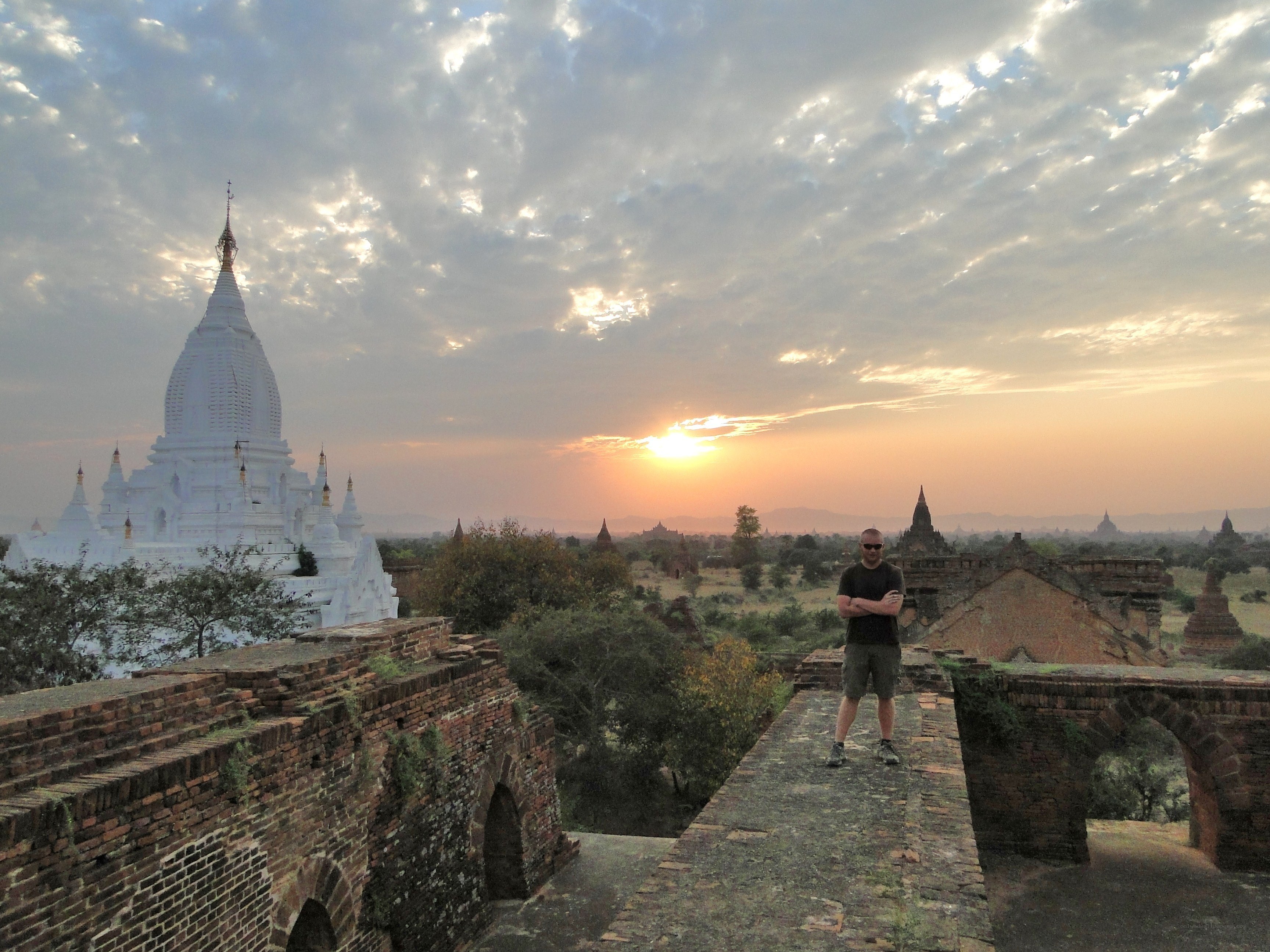 Man at ancient temple at sunset
