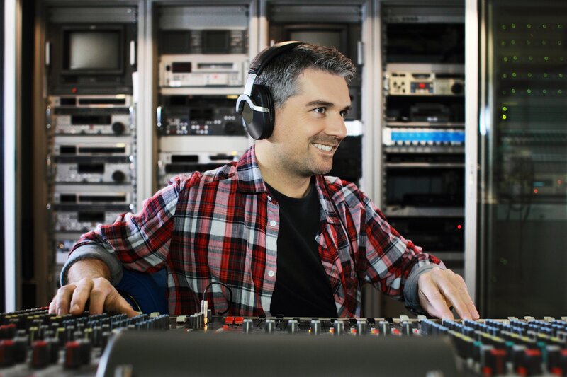 man at audio mixing console