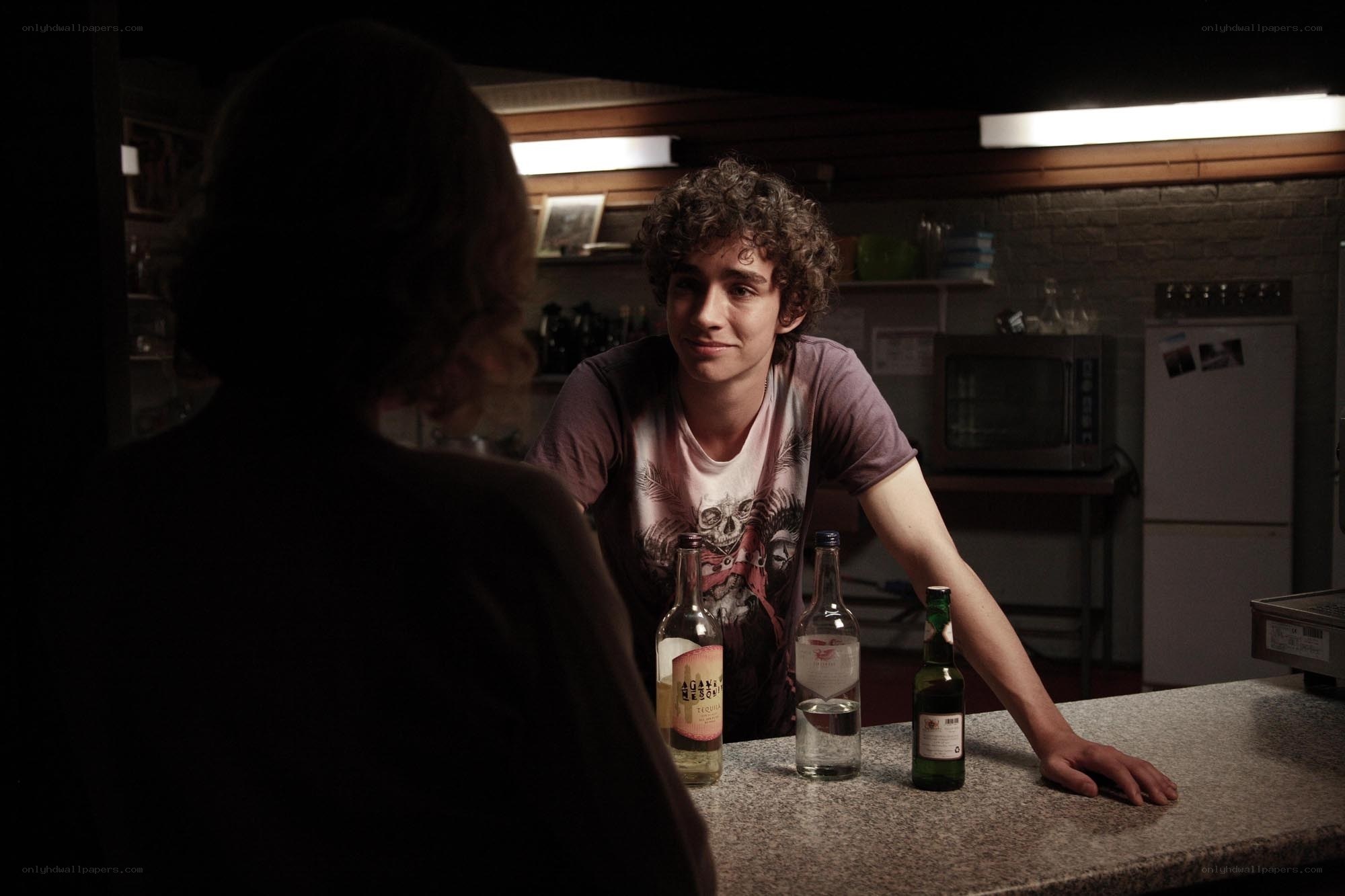 man at bar with bottles