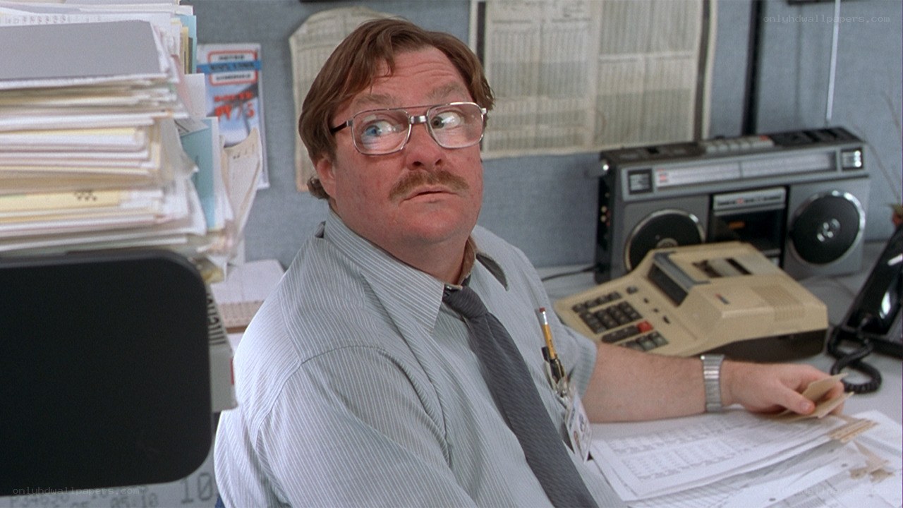 man at cluttered office desk