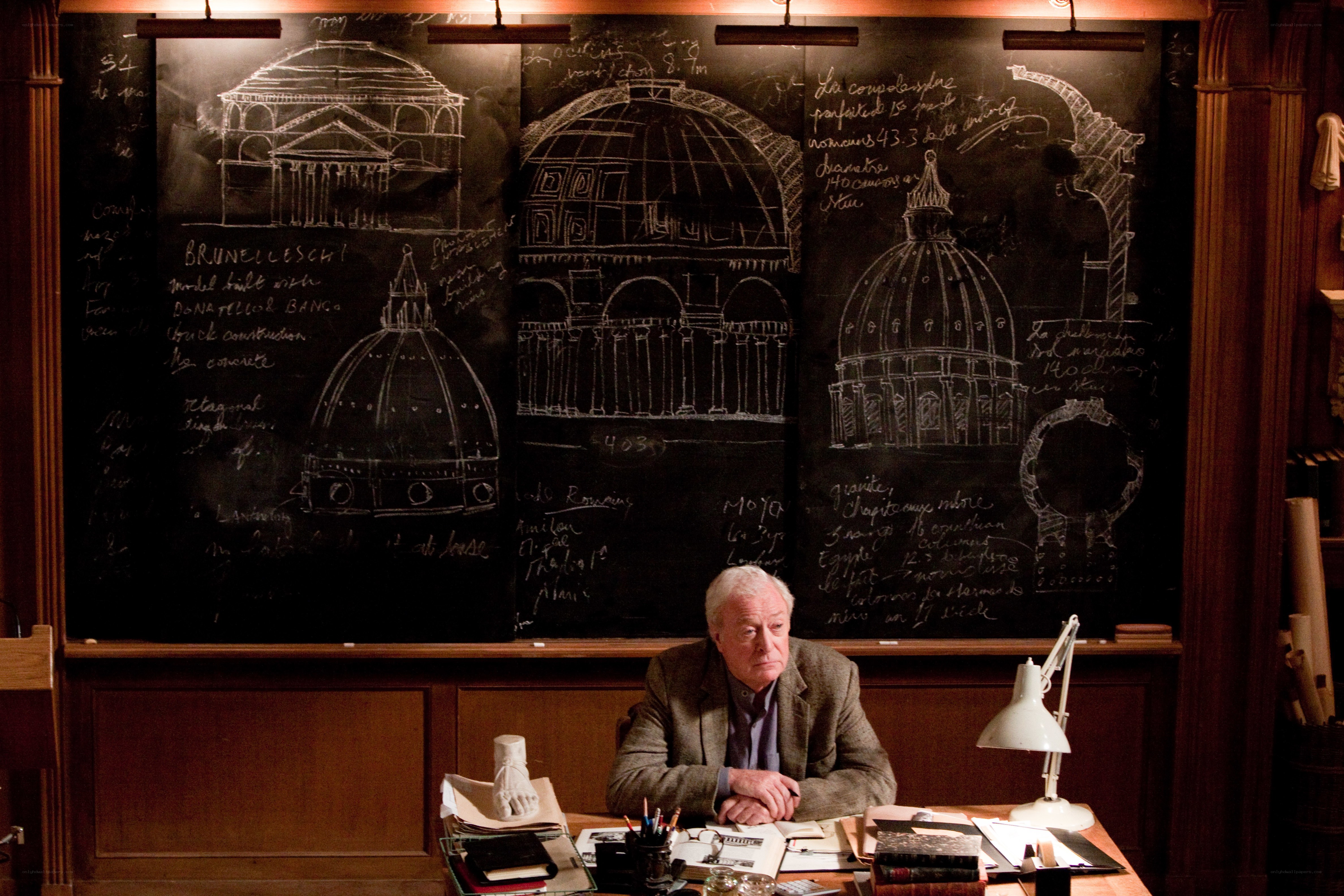 Man at desk with architectural drawings