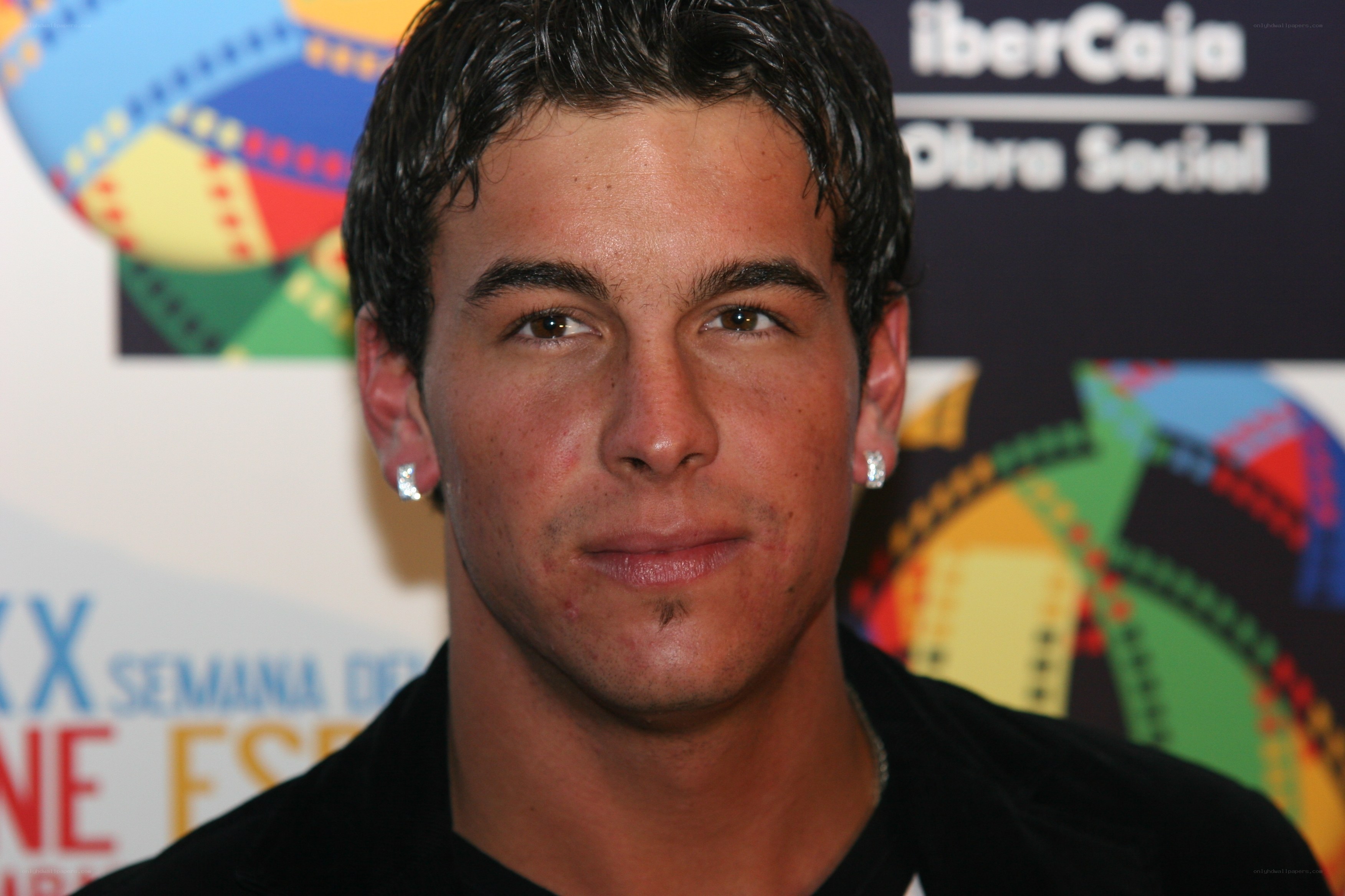 man at event with film backdrop