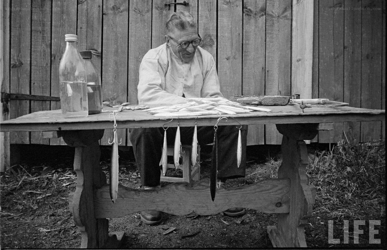 man at fishing tackle table