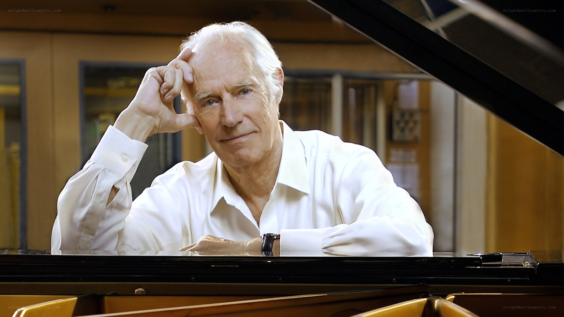 man at piano with hand on head