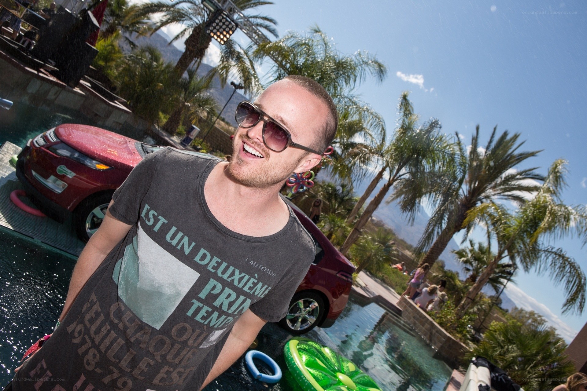 Man at pool party with car