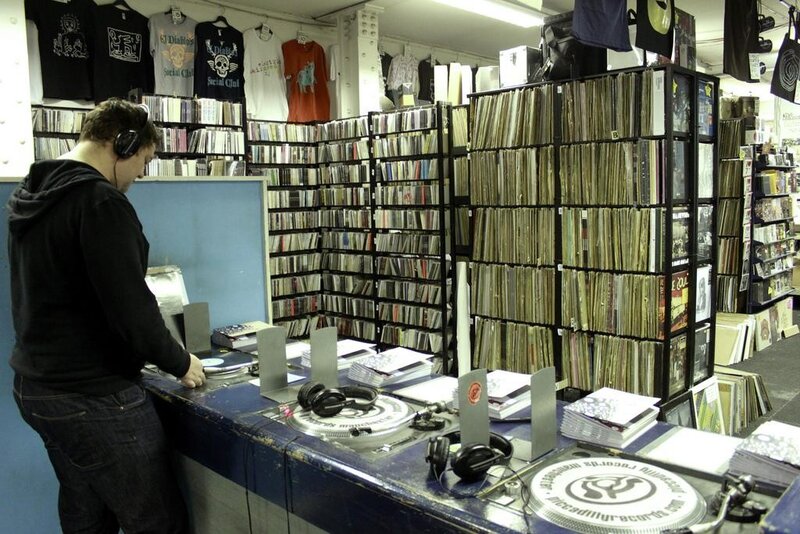 man at record store counter