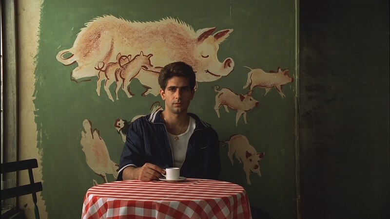 Man at table with pig mural