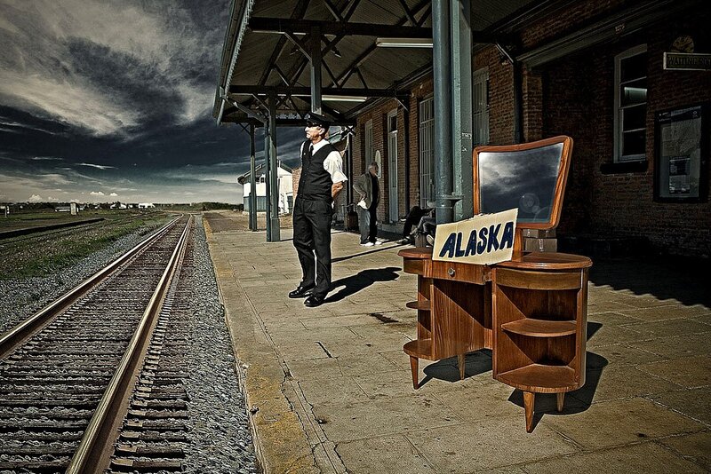 Man at train station with Alaska sign