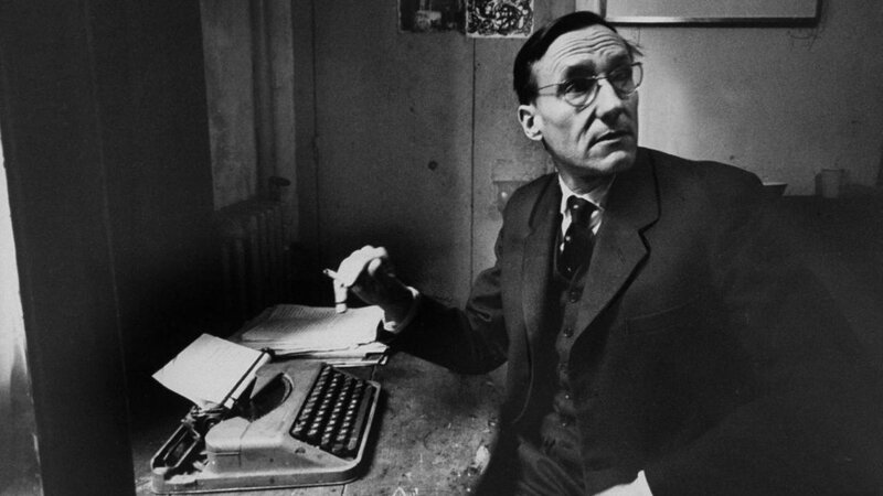 Man at typewriter in study