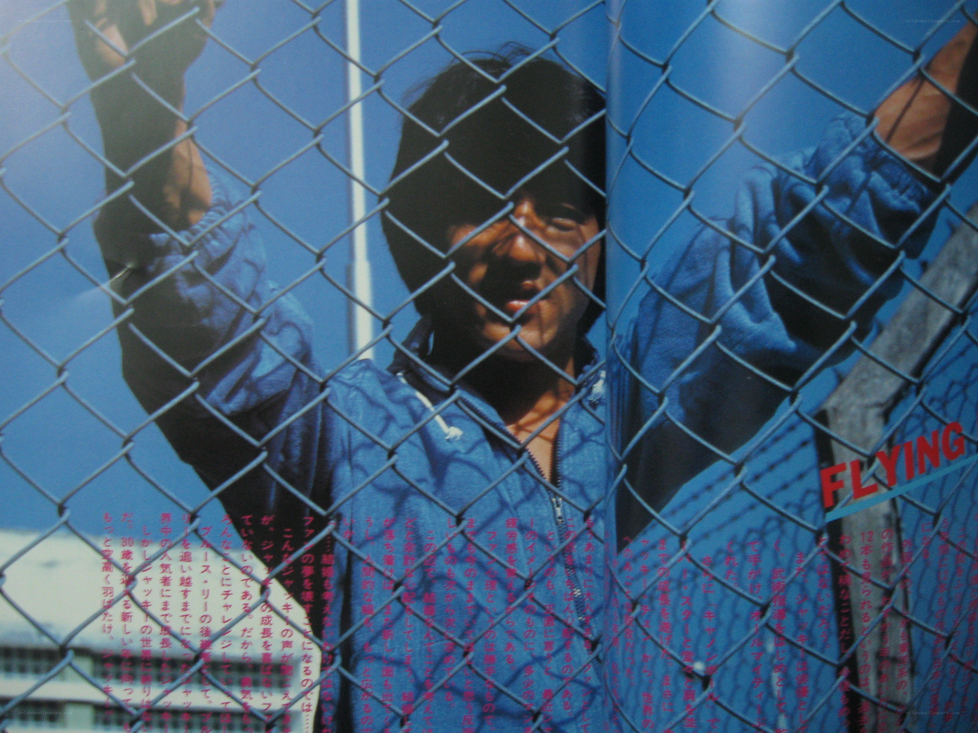 Man behind a chain-link fence