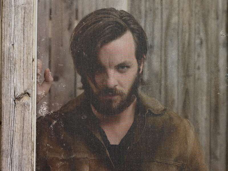 man behind a screen door