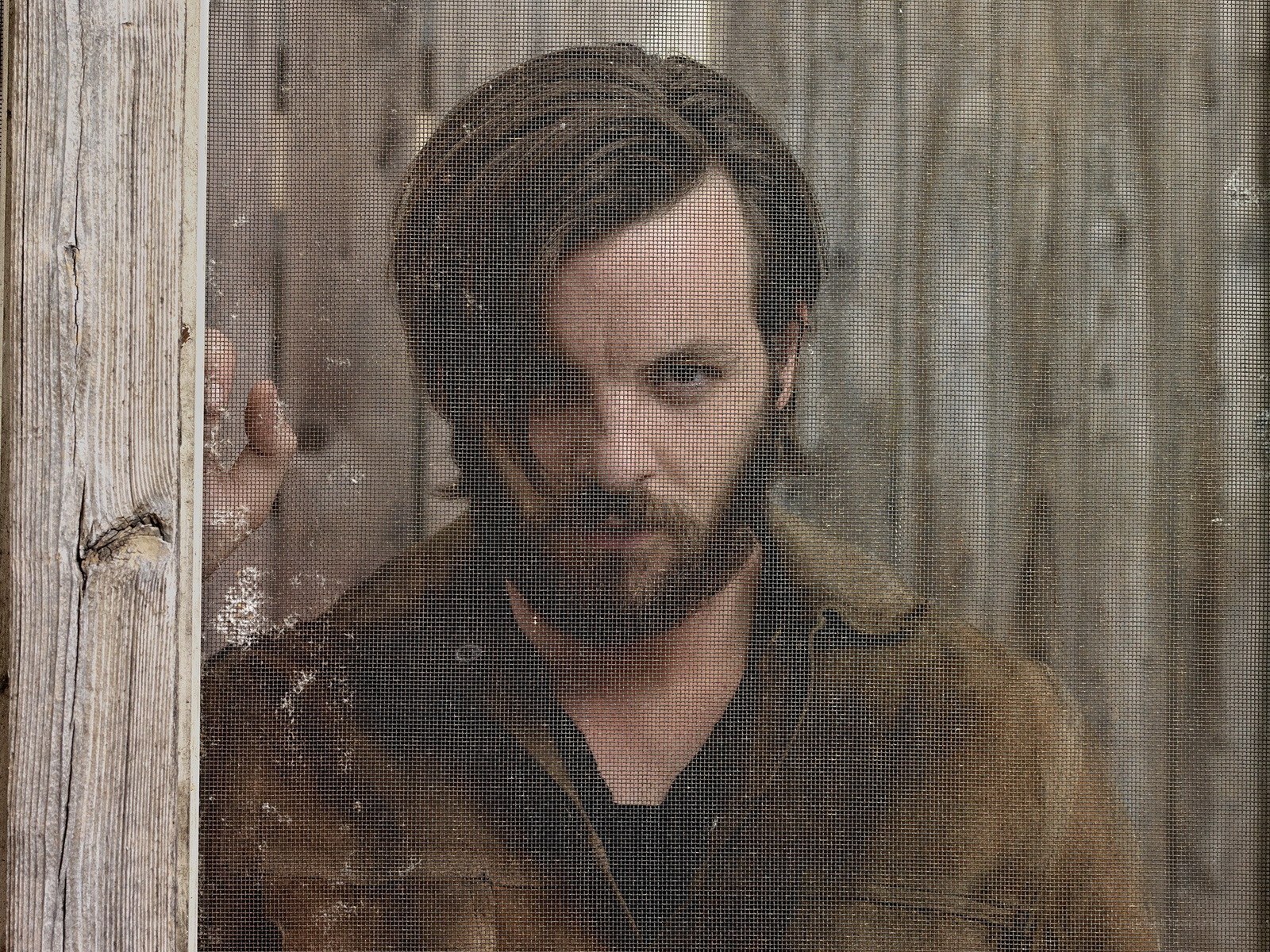 man behind a screen door