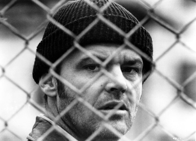 Man Behind Chain-link Fence — Black, Serious