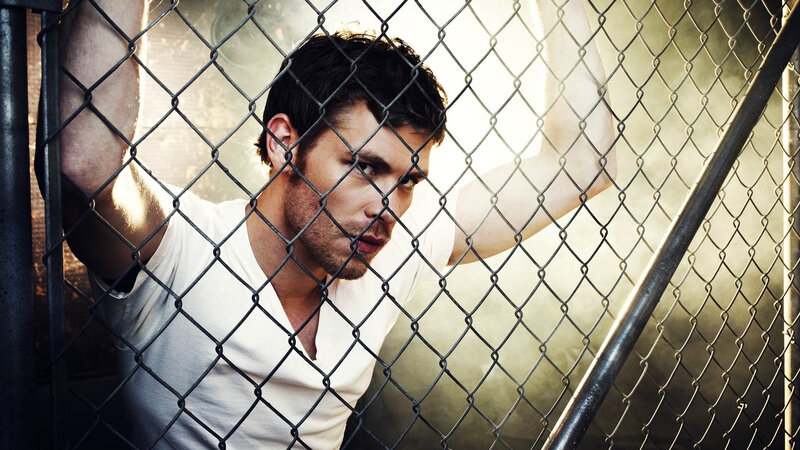 Man Behind Chain-link Fence — Black