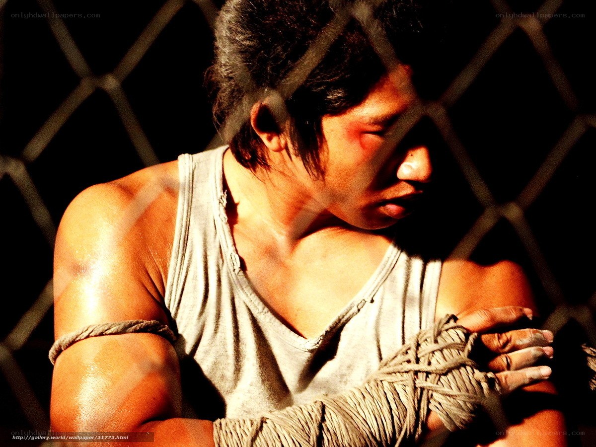 man behind chain-link fence