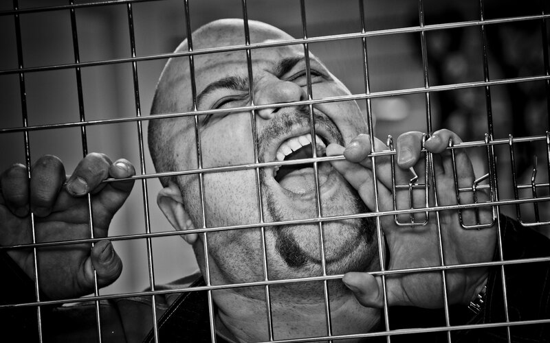 Man Behind Metal Bars