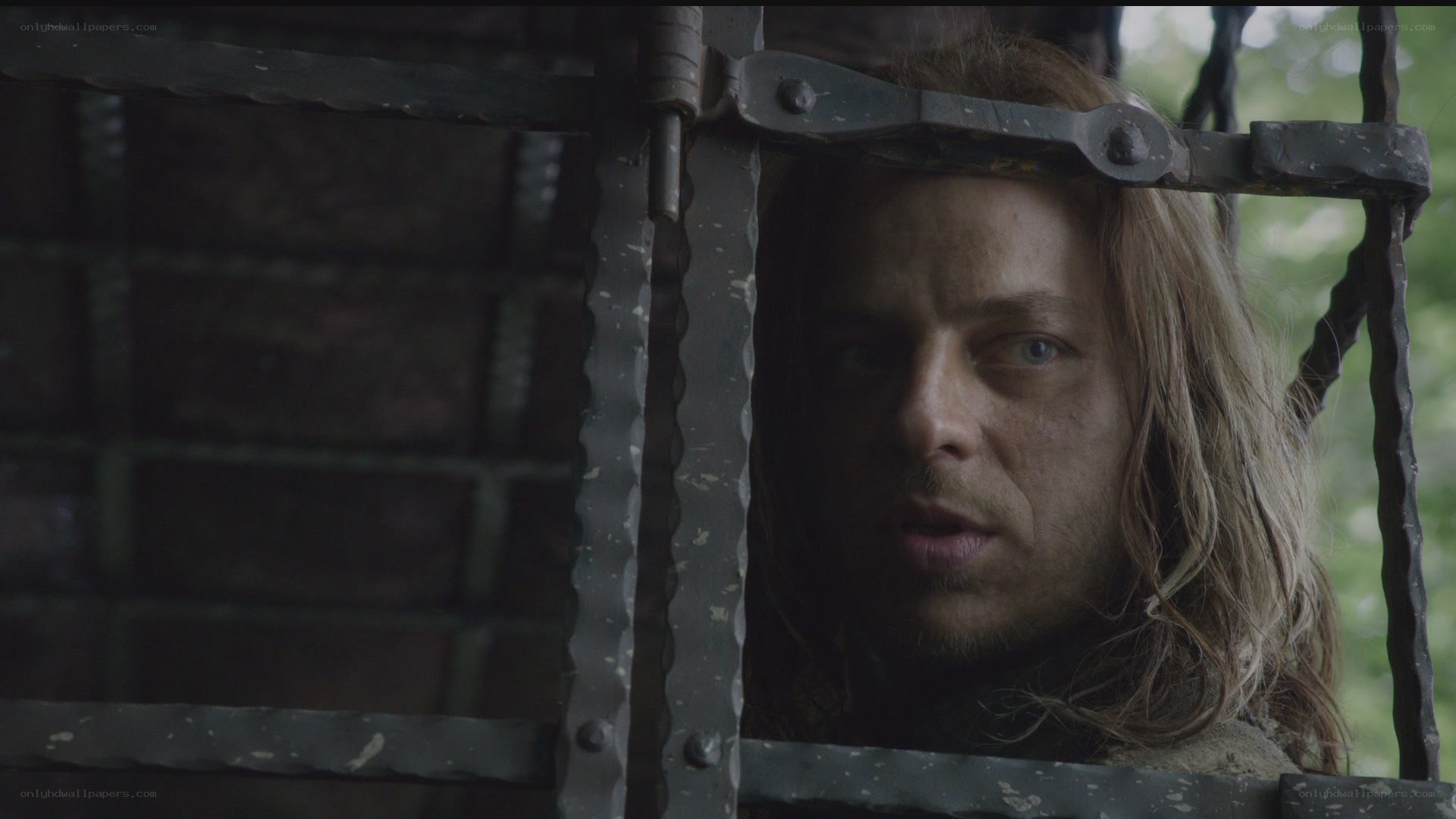 man behind prison bars