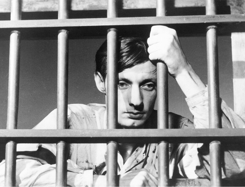 man behind prison bars