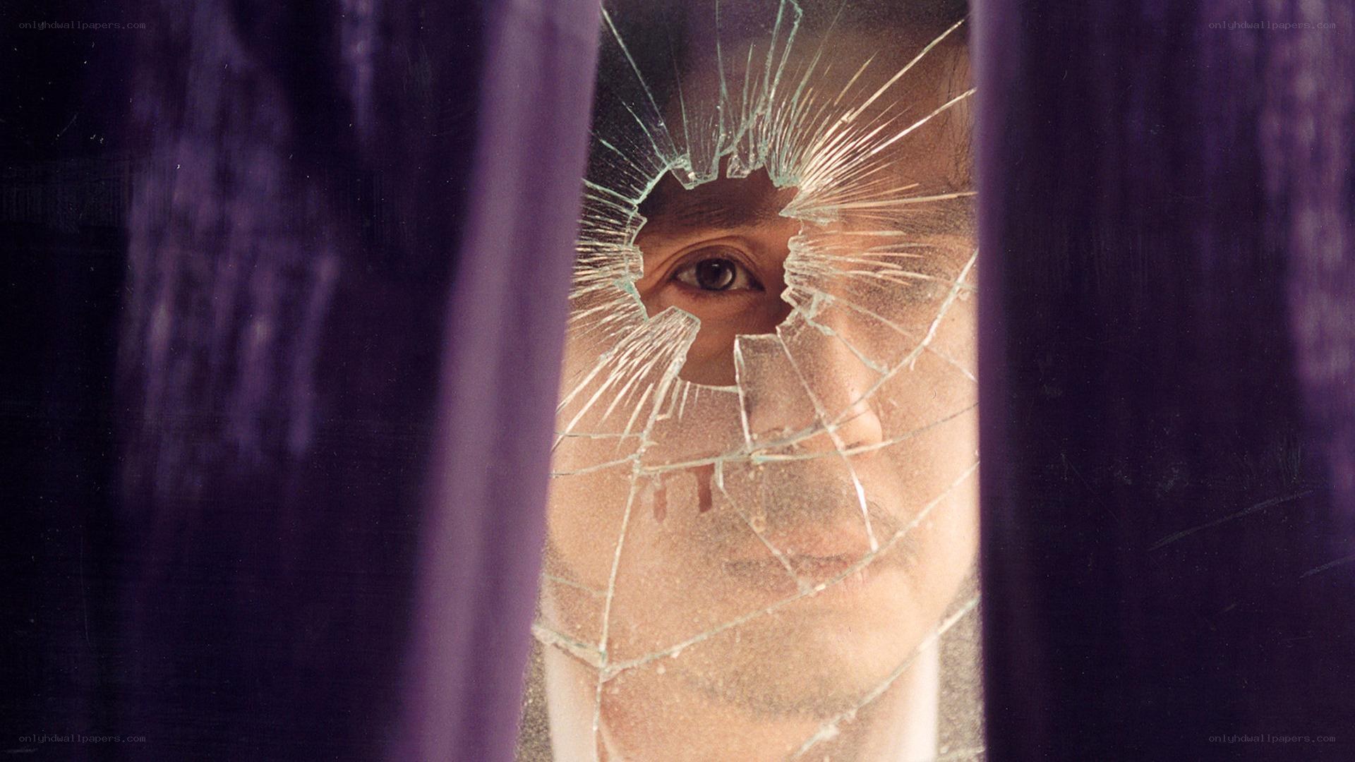 Man behind shattered glass