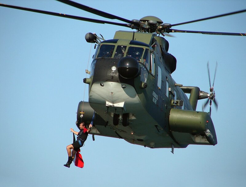 Man Being Hoisted by Helicopter