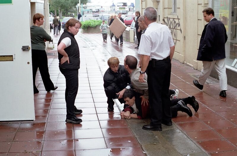 Man Being Restrained on Sidewalk