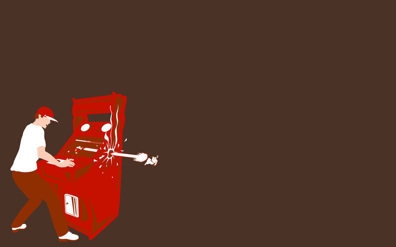 Man breaking arcade machine