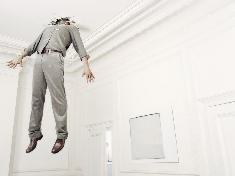 Man Breaking Through Ceiling — White, Dramatic