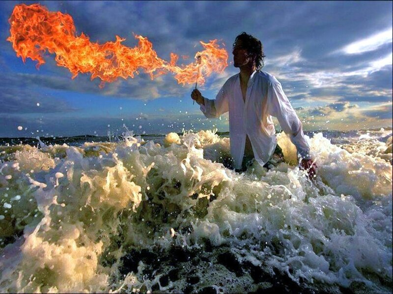 Man breathing fire in ocean