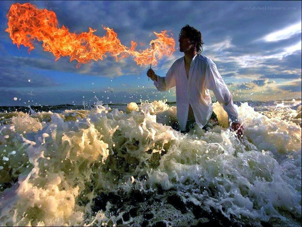 Man breathing fire in ocean