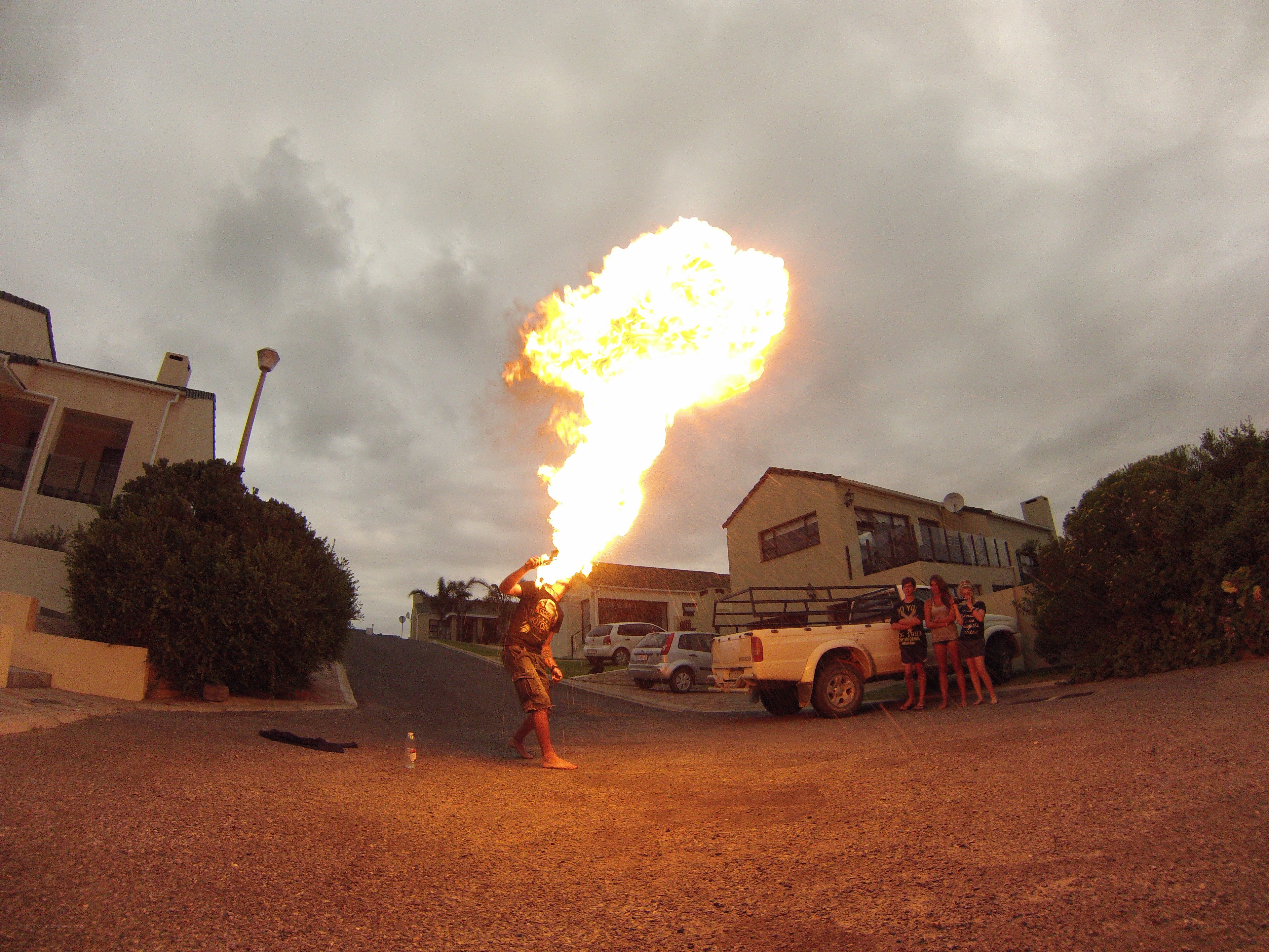 Man breathing fire on street