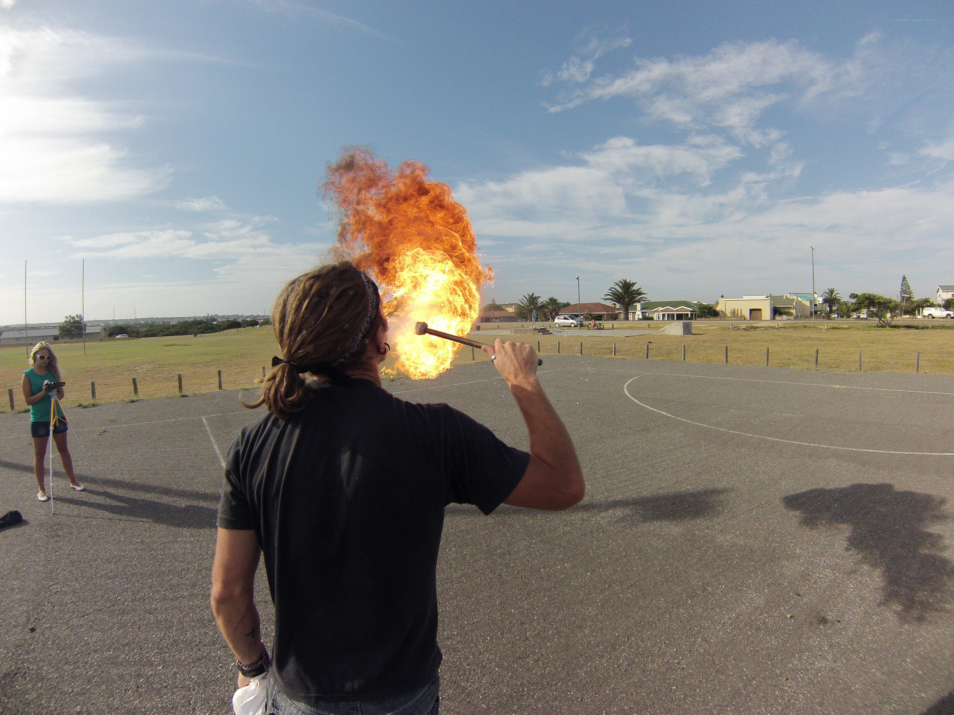 Man breathing fire outdoors
