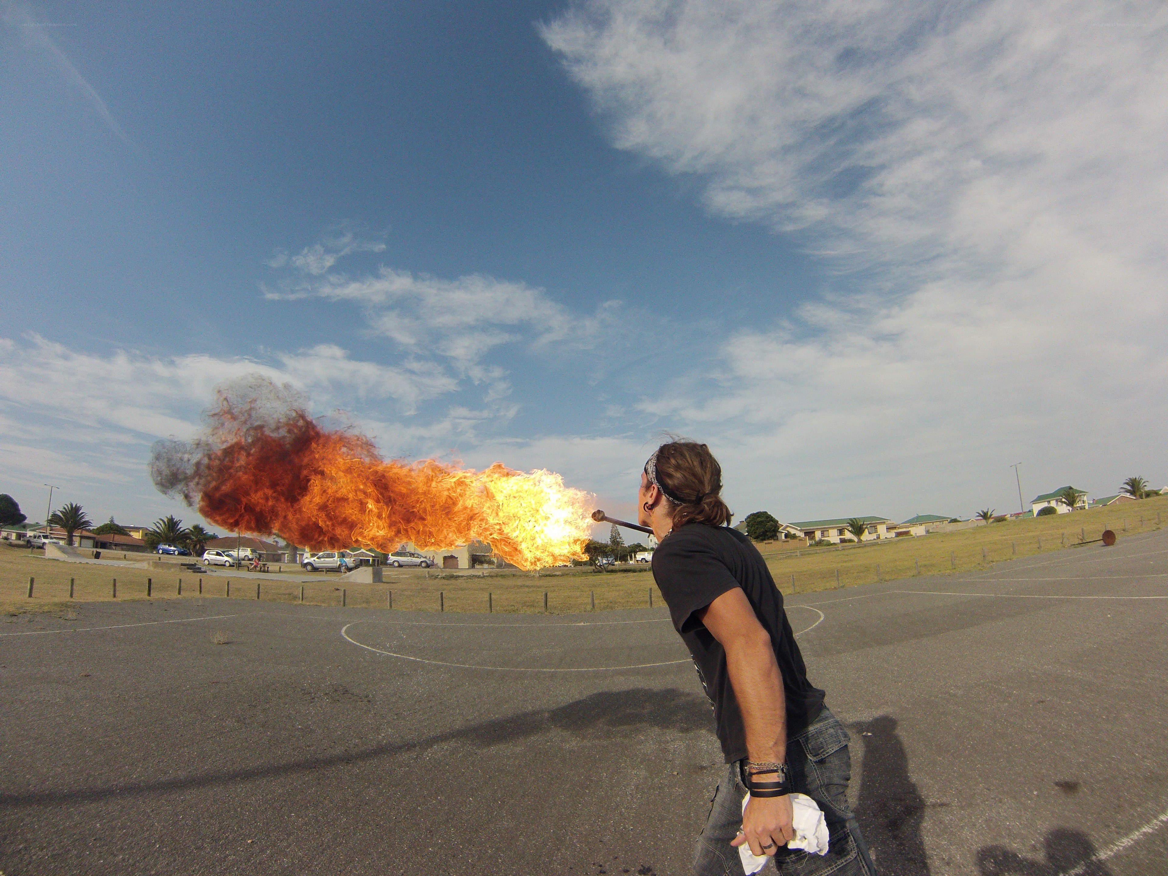 man breathing fire outdoors