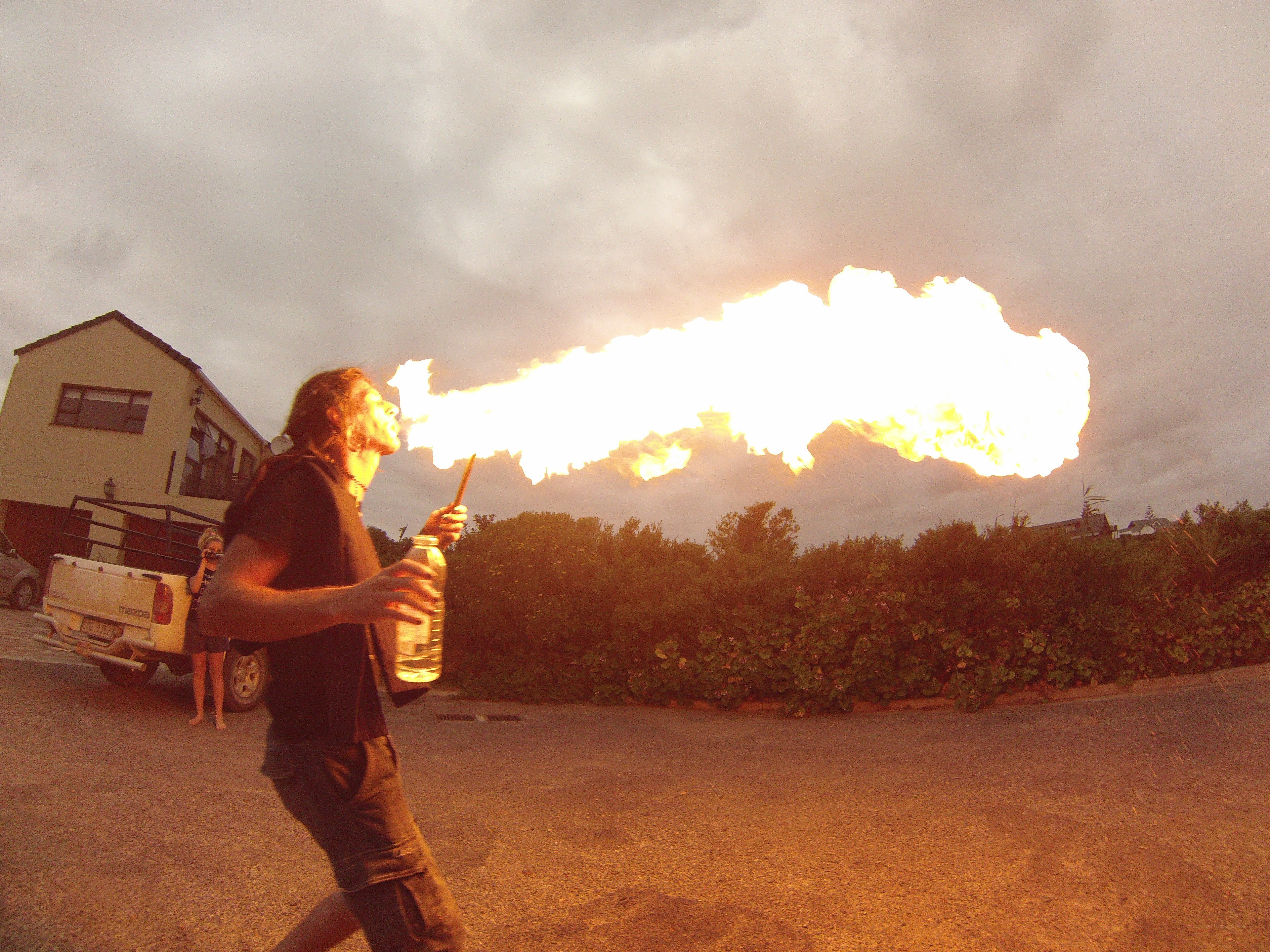 man breathing fire outdoors
