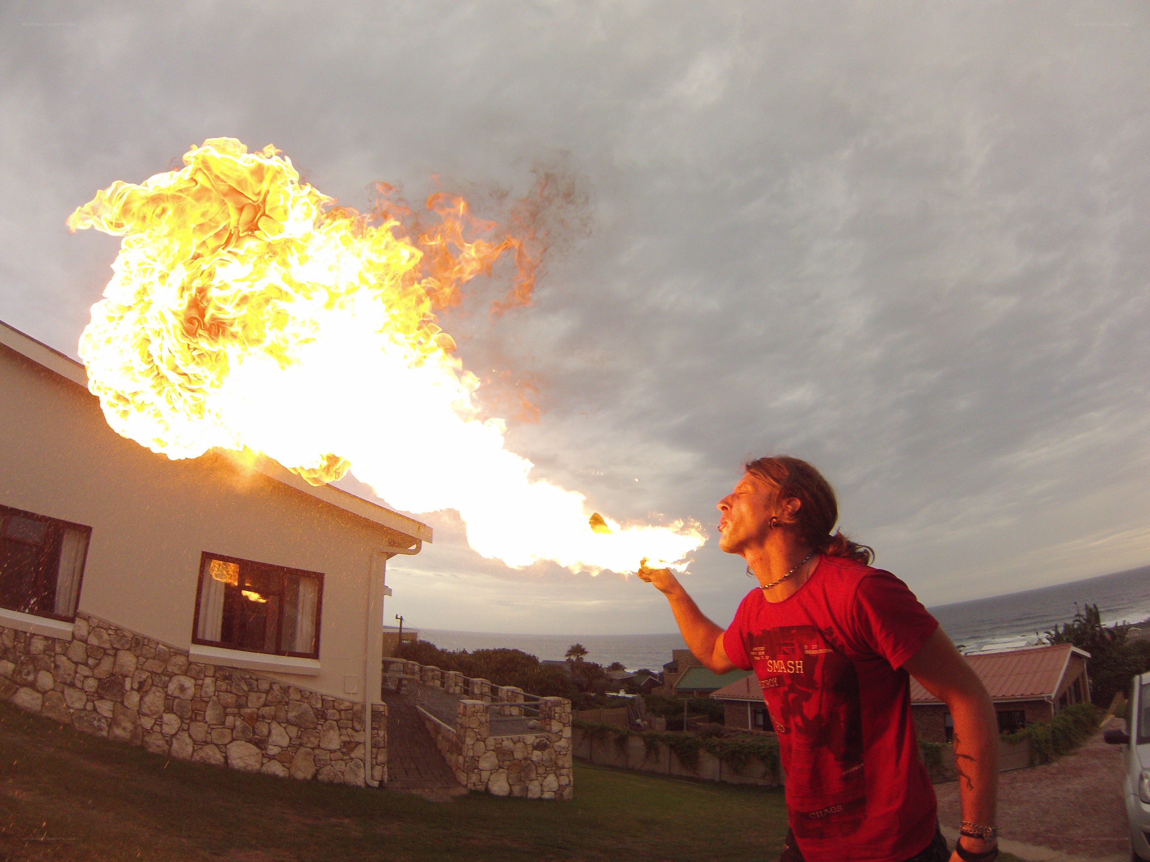Man breathing fire outdoors