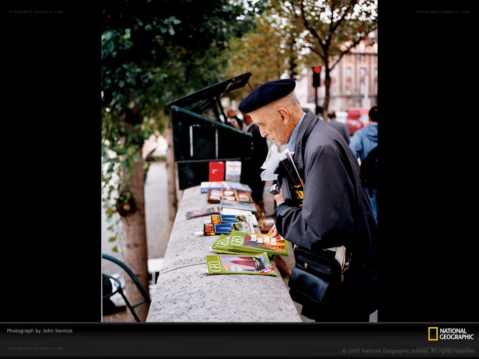 Man browsing magazines at a street stall