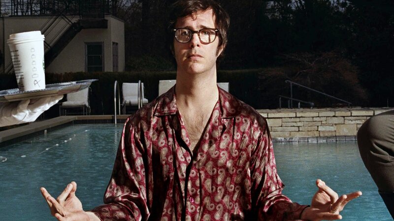 man by pool with coffee cup