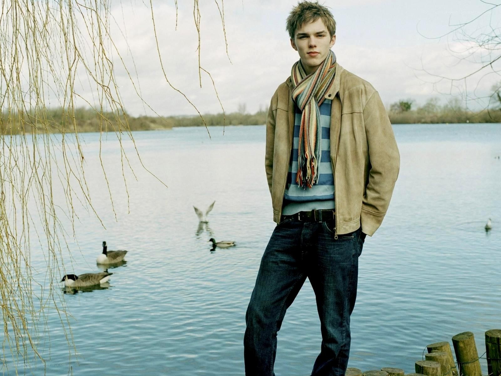 Man by the lake with ducks