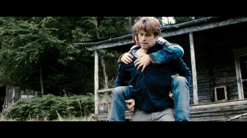 Man Carrying Another Man — Blue, Dramatic